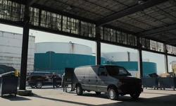 Movie image from Warehouse next to oil tanks