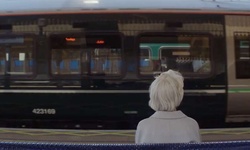 Movie image from Betty and Roy sitting on station platform